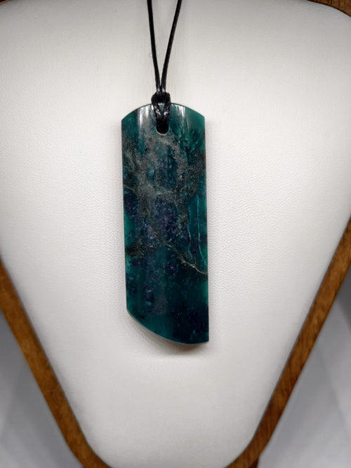 Goodletite pendant on a white surface