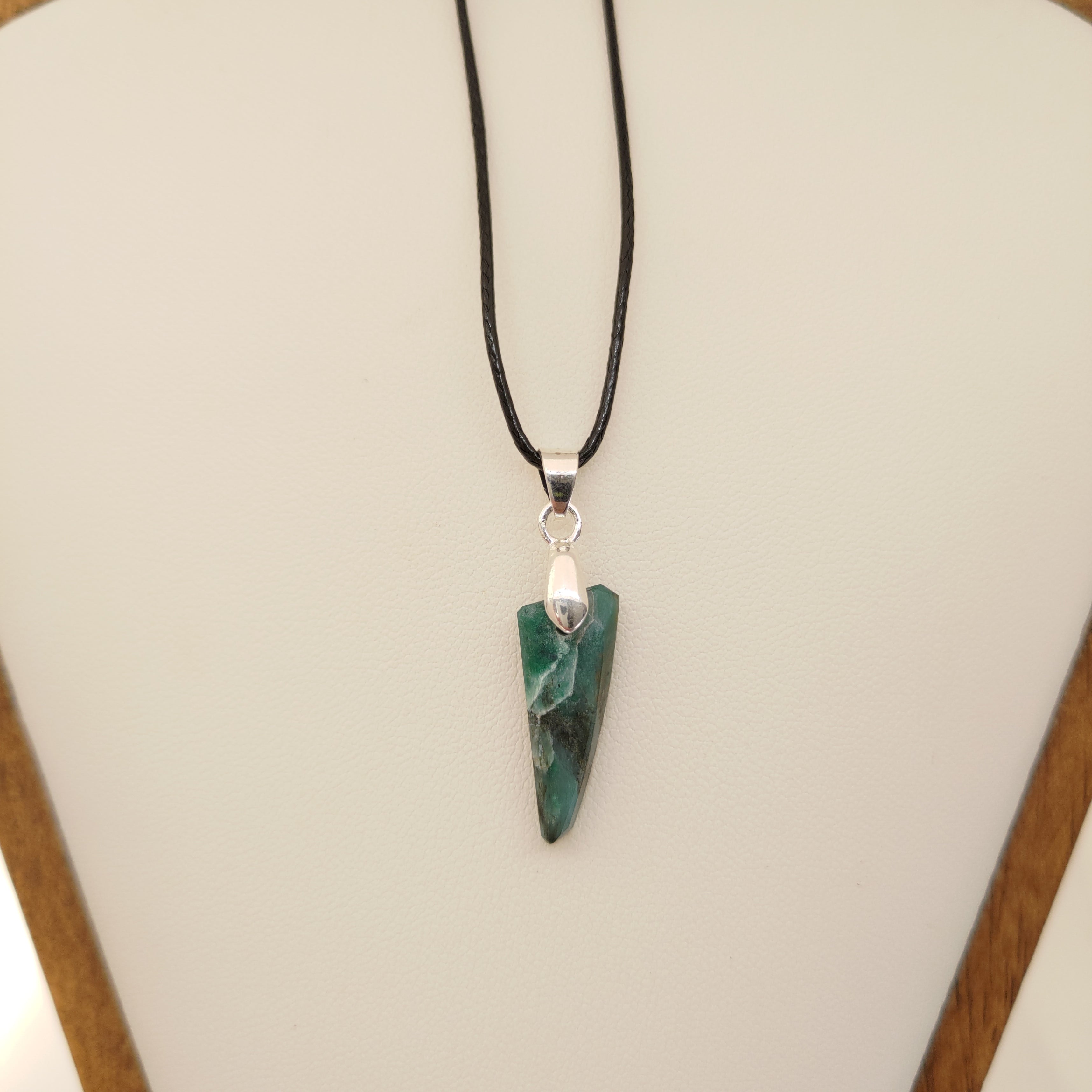 Necklace with a green stone pendant on a white background